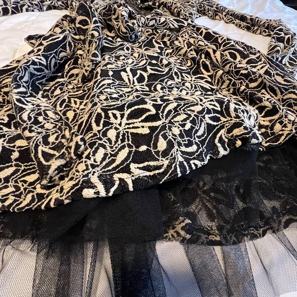 Classy jacket Ties at waist. Small flare on bottom with petticoat attached.